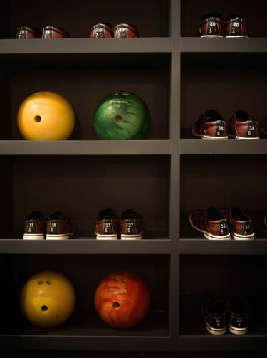 Bowling balls and shoes organized on shelves in the private bowling alley at Villa La Gratitud.