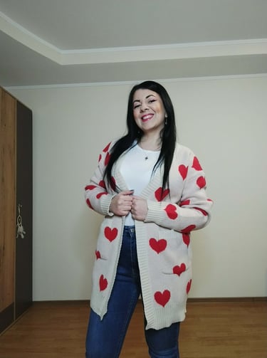 Woman wearing apricot heart print long cardigan sweater with pockets, ribbed knit open front