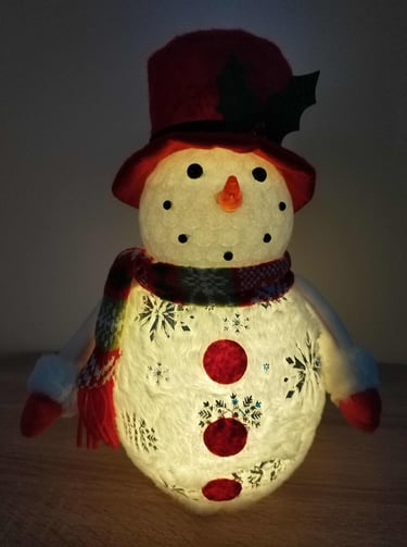 lighted christmas snowman decoration with red hat scarf and glowing snowflake cutouts standing table