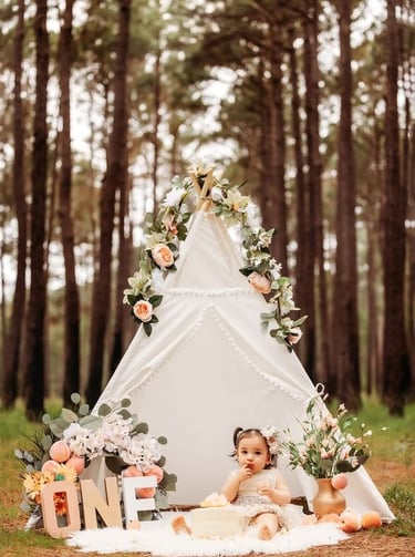 a baby girl in a teepeeh tent with a teepeeh tent