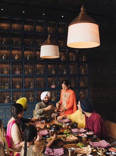 a group of people sitting around a table with food