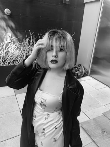 a woman with bangs and a short haircut in a black jacket