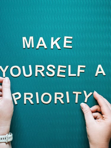 Make yourself a priority motivational quote with wooden letters on a teal yoga mat for self-care.
