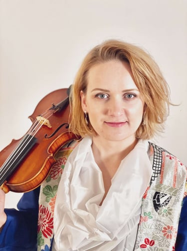 Close-up portrait of Lithuanian violinist Zydre with violin, classical musician based in Kanazawa, Japan