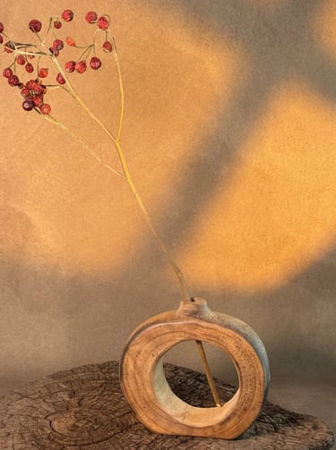 Handcrafted dark bamboo flower vase with a natural textured wood finish and traditional handle.