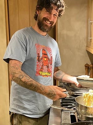 Talbotics t-shirt wearer making pasta.