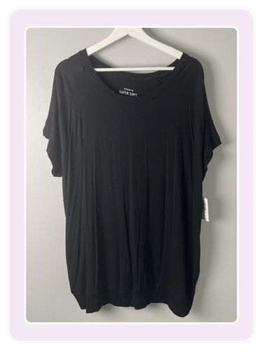 Torrid Super Soft black short sleeve t-shirt with a scoop neck on a white hanger.