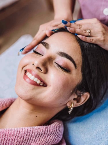 a woman getting her facial massage on the face