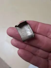 flattened antique silver thimble.