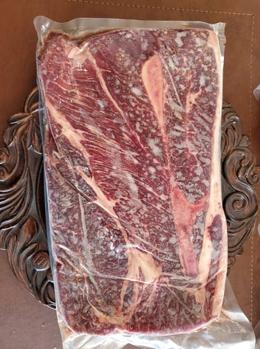 a piece of meat on a table with a knife and fork