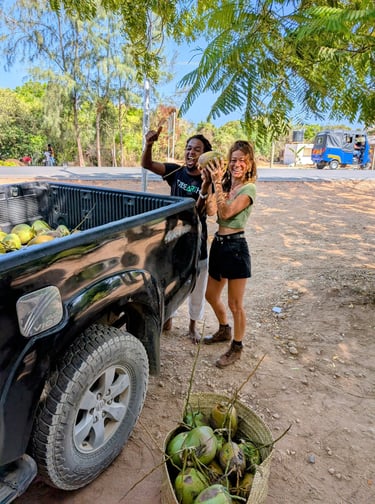 happy customers receive fresh harvested coconuts from the aak farm
