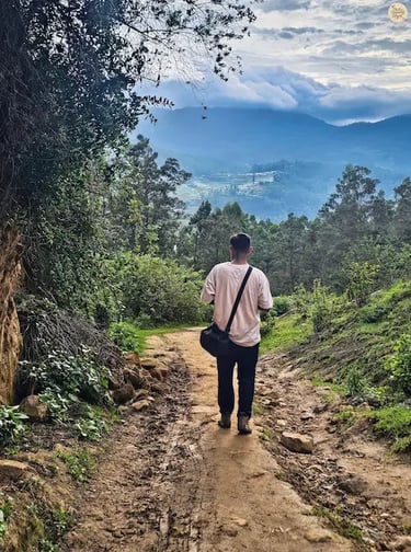 Trekking the muddy trail to Poondi Lake, surrounded by lush greenery and rolling hills.
