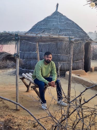 Sitting by a traditional Rajasthani hut in Raisar dunes - living the desert calm of Bikaner.
