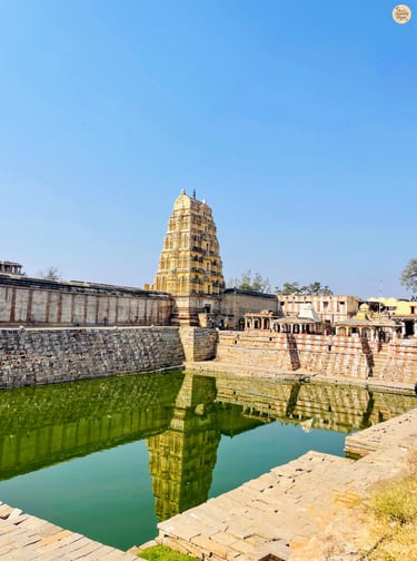 Virupaksha Temple’s Raj Gopuram reflected in Hampi’s sacred Pushkarni.
