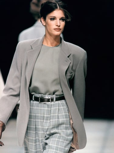 Model in greige Giorgio Armani suit demonstrating fluid tailoring and quiet luxury.