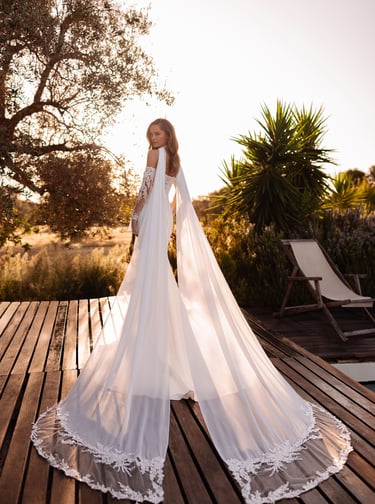 a woman in a wedding dress standing on a deck