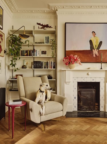 Michelle Dockery’s dog Alfie sitting on armchair in private home.