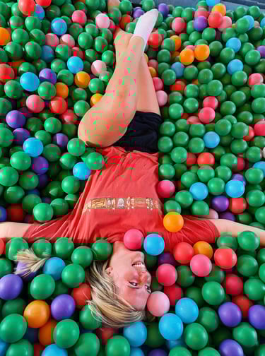 Ashley-Shae Benton filming fun short-form video content in colorful ball pit setting