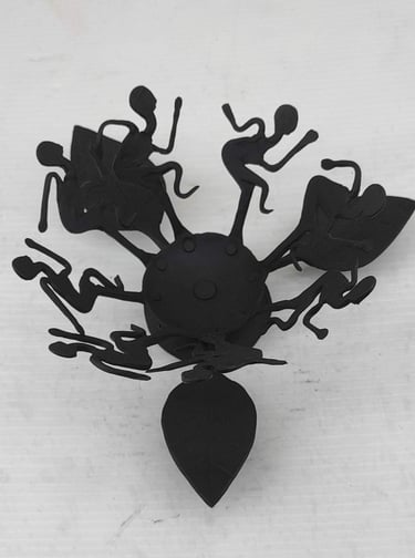 "Handcrafted tribal iron oil lamp with dancing figures–top view–for overseas demand"