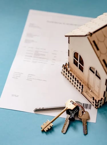 Loan contract with keys and small wooden house, symbol of mortgage approved for first-time buyers