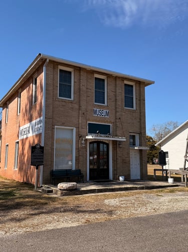 A brick building , museum of hardin county located in Kountze