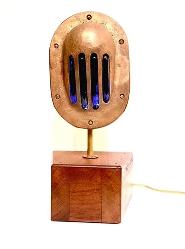 Custom light made from brass boat vent and slumped blue glass.