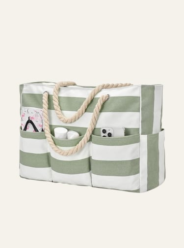 Large green and white striped canvas beach tote bag with rope handles and exterior pockets.