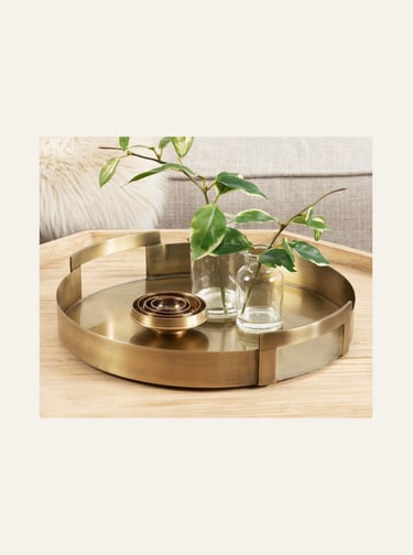 Picture of Transitional Metal Round Tray in gold on a light wood table