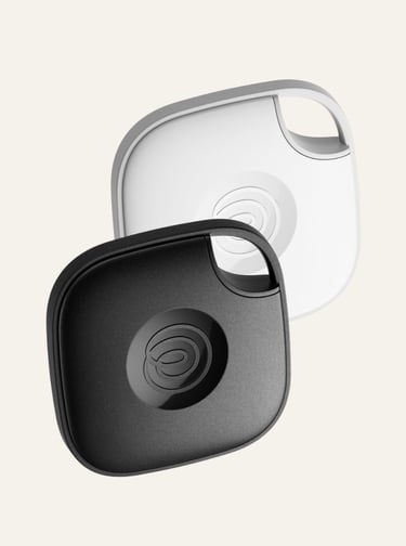Black and white Tile Mate Bluetooth trackers for finding lost keys and luggage.