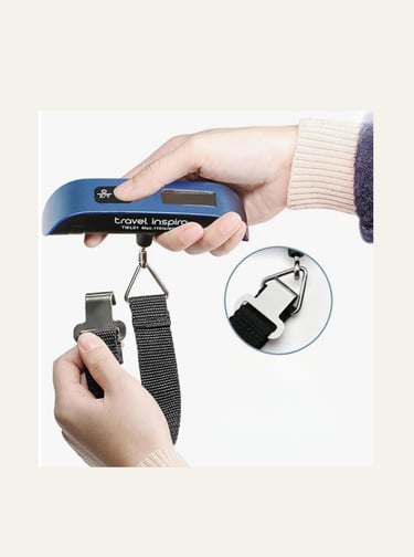 Portable digital luggage scale with a blue handle being held to weigh a suitcase with a strap.