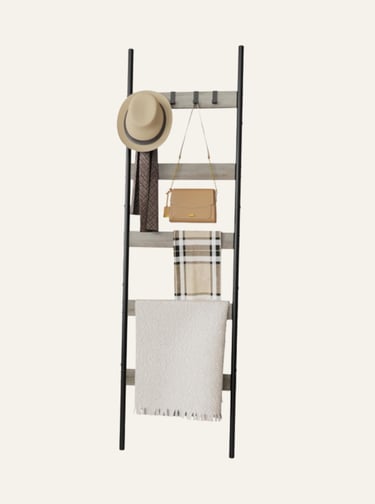 Rustic wood and black metal decorative ladder rack holding a hat, purse, scarf, and blanket.