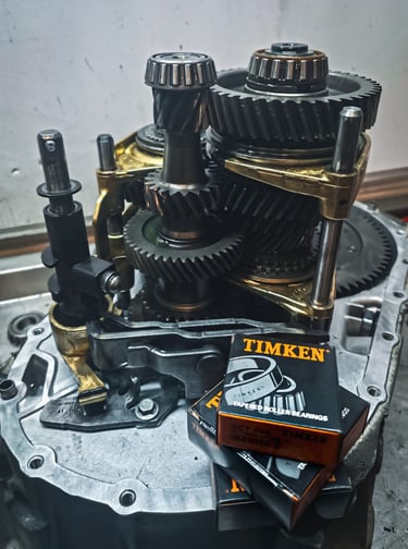 Manual transmission gear assembly with new Timken tapered roller bearings for automotive repair.