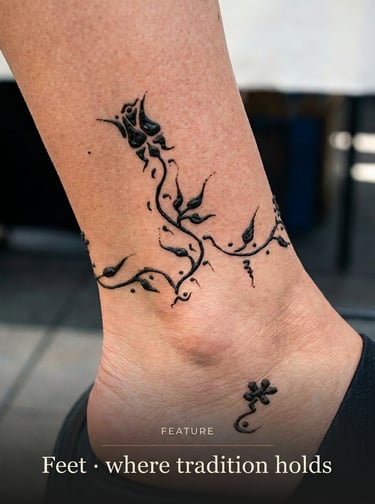 A detailed black henna floral anklet tattoo design on a person's ankle.