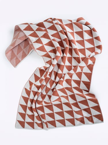 a blanket with a geometric pattern