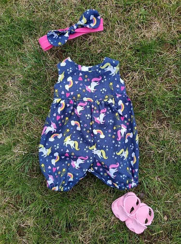 Wollyonline 1624 view E romper in unicorn print with matching hair bow