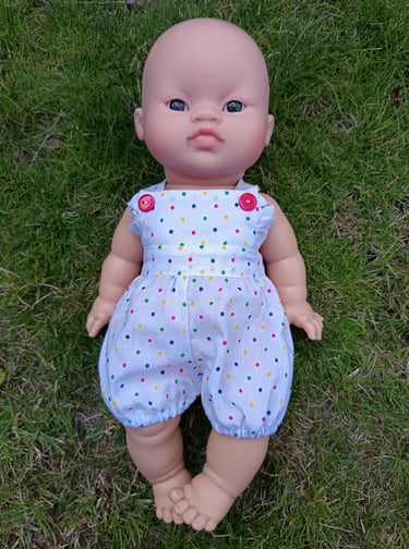 Minikane doll Mai Ly dressed in a tiny polka dot summer romper