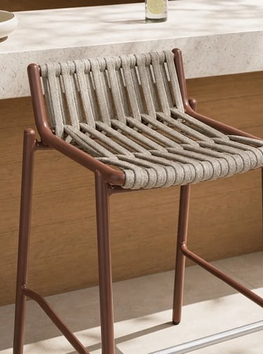 Close-up of a woven outdoor chair with a slim frame, designed for comfortable balcony seating and sm