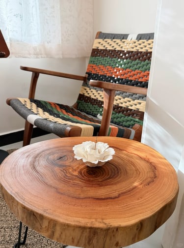 Comfortable balcony reading nook with soft cushions, greenery, and a small table for coffee and book