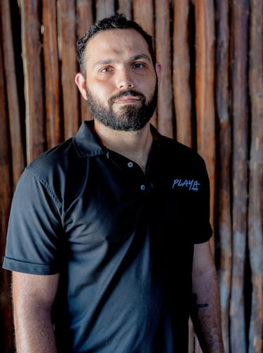 Sebastian Serrano wearing a Playa Films t-shirt, showcasing the video production team in Playa del C