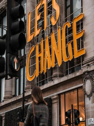 Large sign reading “Let’s Change” on a city building. 