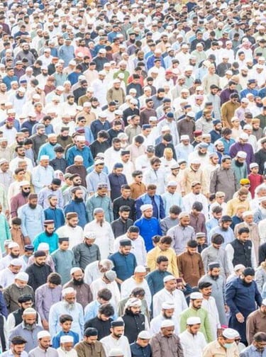 Large group of people gathered in prayer, standing closely together