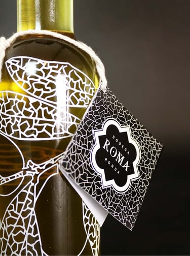 Close up of an olive oil bottle on dark background