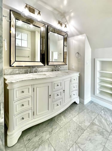 Bathroom with traditional architectural style, beautiful radius wood vanity, and marble countertops.