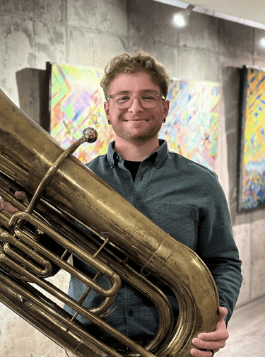 Christian Bidwell-Thompson holding his tuba