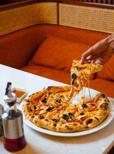 Wood fired pizza served at Haloz Pizzeria Lucknow