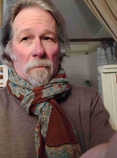 a man with a beard and a scarf around his neck