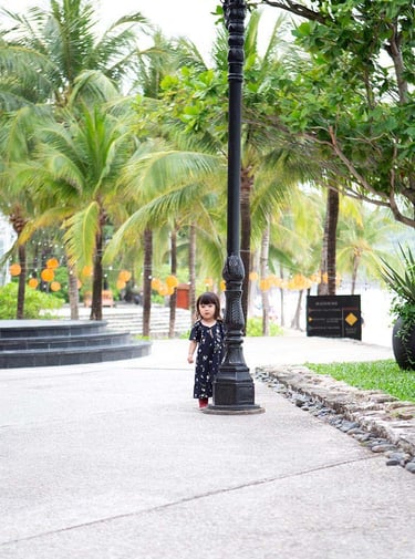 Child walking near tropical palms at JW Marriott Phu Quoc
