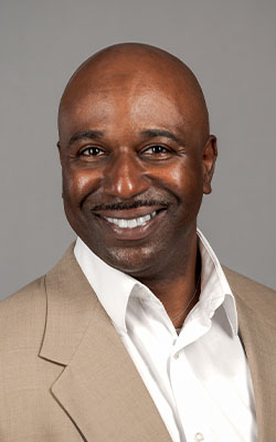 Louisiana business professional in a suit and white shirt poses for a headshot