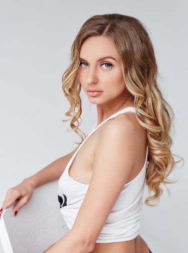 a woman in a white top and jeans shorts