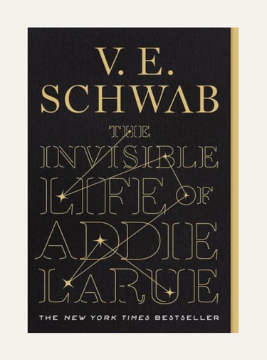 Book cover for The Invisible Life of Addie LaRue by V.E. Schwab featuring gold typography on a black background.